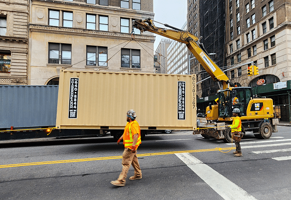 Modular container being loaded on a truck