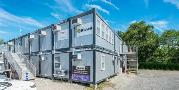 Modular office building with air conditioning units under a blue sky.