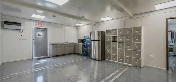 Spacious break room with lockers fridge and kitchenette in an industrial setting