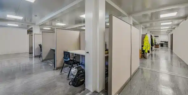 Modern office space with cubicles and a reflective floor ambiance